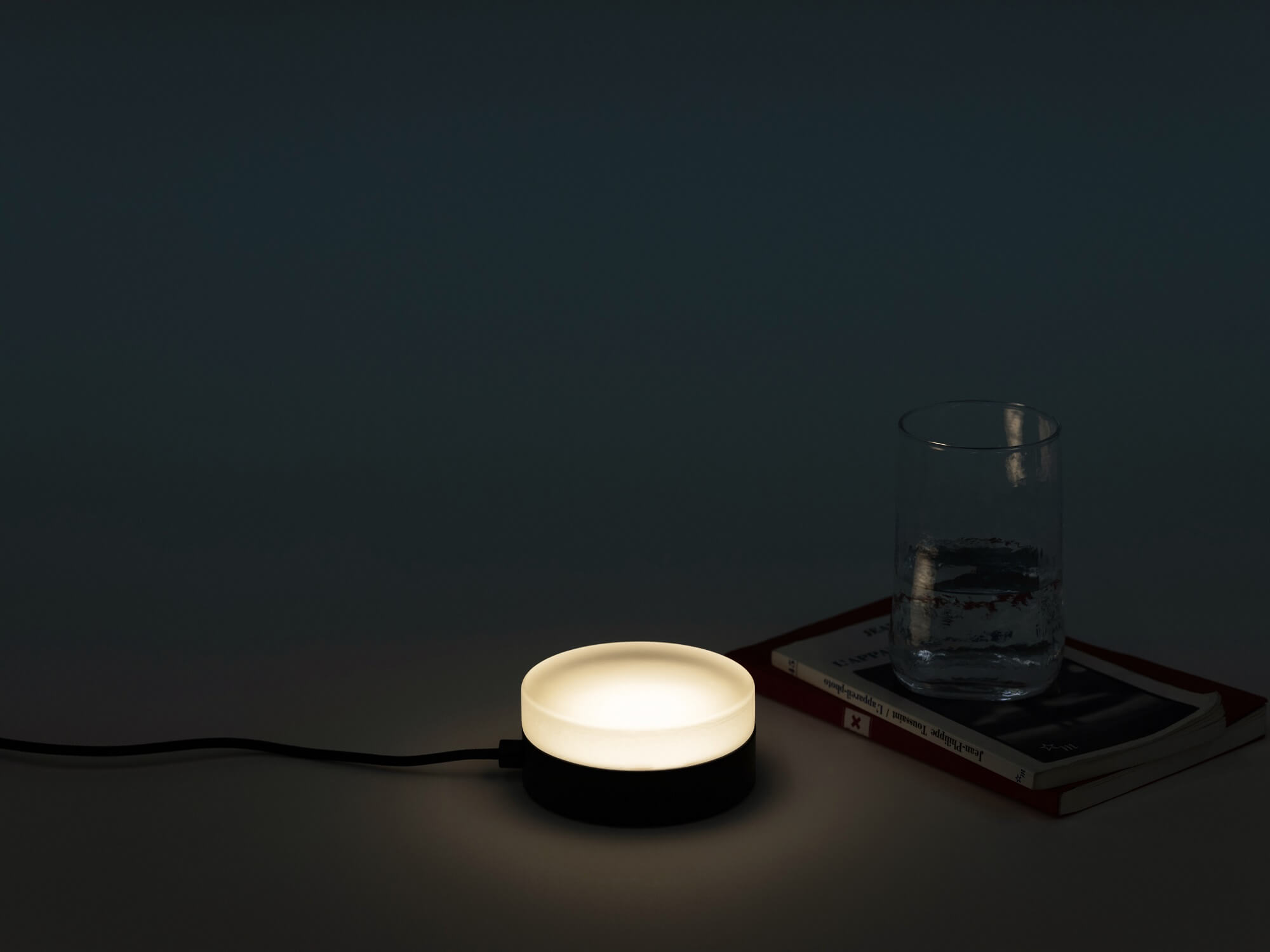 The Row Puck desk lamp with light on